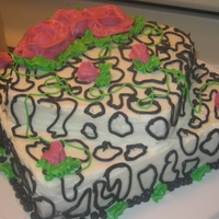 Black And White With Roses 2 tiered cake...9 in square on bottom...6 in square on top. Triple chocolate decadence cake with almond buttercream. *My four year old...