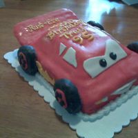 Fondant Lightning Mcqueen My very first fondant cake. I froze the cake, shaped it and built it. The wheels I made out of rice crispie treats and covered.