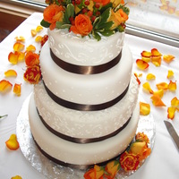 Autumn Wedding Fondant covered with royal icing piping. Each tier was a different flavor, Tops was carrot, middle was chocolate, and bottom was almond...