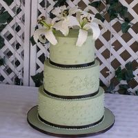 Sage Green With Lilies This cake consists of 12"x5", 10"x5" and 8"x5" tiers. Iced with buttercream icing and trimmed with chocolate...