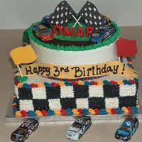 Nascar Theme Cake 2 tiers choc and vanilla all BC. The flags are chocolate transfers and the cars are foiled covered chocolate I bought.