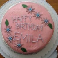 Emilas_Birthday_Cake.jpg A red velvet cake with cream cheese frosting.Flowers made out of fondant.