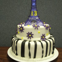 Eiffel Tower Cake 2- 8" layers & 1- 6" layer WASC, buttercream icing, fondant stripes & flowers. Tower provided by customer for her 13 year...