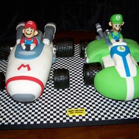 Mario 7 Luigi Kart Cakes Had to make these both at the same time- double birthday . Wheels are RKT covered w/fondant, Figures are gum pate, The rest is yellow cake...