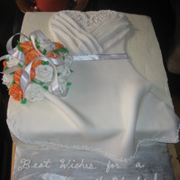 Annie's Bridal Shower I made a fondant dress with a bouquet of royal icing roses with edible pearls in the center.