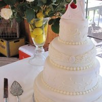 Buttercream Dream Buttercream iced wedding cake with buttercream piped decoration , fondant oval decoration .