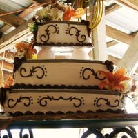 Western Theme Cake This was my first square wedding cake. Chocolate cake marbled with vanilla, and strawberry filling. Wipped cream frosting, with fudge...