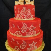 Mehindi Cake This cake was done for a Hindu couple. The baby elephants are fondant. The cake was airbrushed red and the Mehindi patterns piped with...