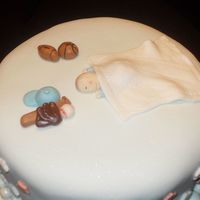Sleeping Baby On Sports Theme Cake Gum paste baby with MMF sports ball and bats.