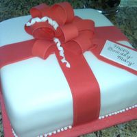 Gift Box Cake Chocolate cake with fresh strawberry filling. Bow was made with 50/50 fondant/gumpast, the rest is covered with fondant. Thanks for viewing...