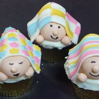 Peeking Baby Cupcakes I made these for a charity auction. They are apple fudge cupcakes with fondant and gumpaste decorations
