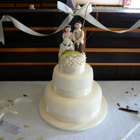 The Best Two Catches Fruit cake bottom and sponge middle tier fondant covered with royal iced fruit cake topper. Comical bride and groom topper. Groom being a...