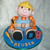Bob The Builder Fondant paste covered sponge cake 3 d figure cake. Covered in fondant paste with modelling paste decoration.