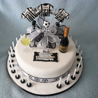 Football Supporter's Cake Sponge covered with fondant paste with decorative spray, made with pastillage football kit and plastic cake decorations.