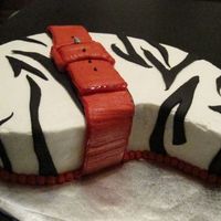 Zebra With Belt This cake was inspired by my friends birthday dress. She wore a zebra dress with a red patent leather belt. The cake is buttercream with...