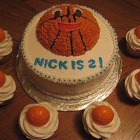 Basketball Birthday chocolate cake with raspberry filling. All buttercream. Cupcakes are vanilla with white chocolate molded basketballs