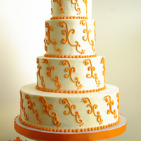 Orange Scrolls 4 tiers - 4,6,8,12. All buttercream with orange scrolls.