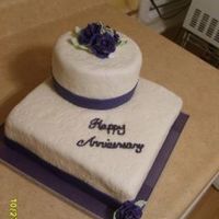 Anniversary Cake Top tier is 6 in. chocolate cake. Bottom is 10 in. square white cake. All covered in MMF.