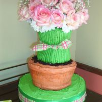 Flower_Cake_003.jpg This is a birthday cake that I made for my daughter. I almost bit off more than I could chew! The flower pot split and I had to compensate...