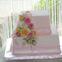 Romantic Roses Pink butter cream over chocolate and almond cakes wrapped in a fondant pearled ribbon. Roses are gum paste and matched her shower...