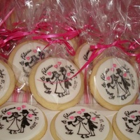 Bride And Groom Sugar cookies royal iced with fondant disk pressed onto royal icing then stamped with gel color mixed with rum.