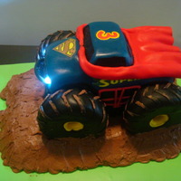 Superman Monster Truck Working Headlights Made this for my grandson's 3rd birthday. The cake was carved, then covered in MMF, the tires are RKT covered in fondant, the "...