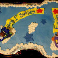 1St Birthday This is an all butter cream covered cake with fondant flags. The planes are super why toys.