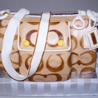 Coach Pocketbook Red velvet cake w/ BC filling. Covered in BCF and MMF. All details are MMF and painted freehand.