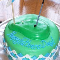 Golf Cake For my husband who is a golfer;Chocolate fudge cake w/ BC filling. Covered in BC frosting and MMF. All decor is MMF the handle for the golf...