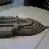 Building This is a Chocolate Grooms cake. It is made with 2 layers of fondant. The windows were cut out so it can give it a realistic look. This was...