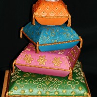 Pillow Wedding Cake Sari inspired wedding cake. The topper is a handmade lotus flower to coordinate with the theme of the cake.