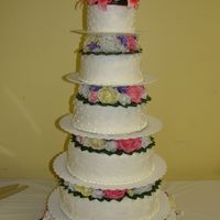 Five-Tier Wedding Cake This is my first wedding cake. It was iced and decorated with buttercream. The flowers are silk and were added by the florist.