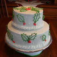 Holly Leaves And Berries Iced in buttercream with royal icing decorations. This cake was inspired by gourmetcakes.