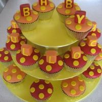 Baby Shower Cupcakes Yellow, Red and orange fondant acents on my famous secret recipe chocolate mudcake! For my friends baby shower. Hand made stand inspired by...