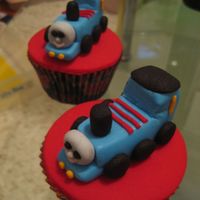 Thomas The Tank Engine Cupcakes Hand made Thomas the tank engine cupcake toppers on vanilla dairy free cakes. Made for party favours.