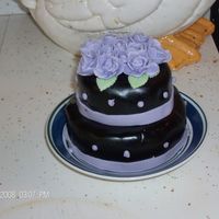 Mini Wedding Cake My first cake, A mini wedding cake, two layers. I was in a hurry to do it so the ribbon lining came out crooked. All in all it came out...