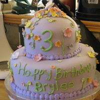 Flowers And Butterflies two tier fondant covered cake with gumpaste flowers and royal icing butterflies and piping.