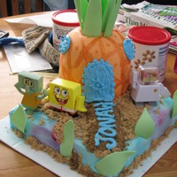 Spongebob's Pineapple Ran out of time to make t he fondant figureines, so these are toys. Pineapple is carved cake covered in fondant with gumpaste stems....