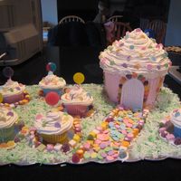 Candyland Cake Wilton giant cupcake pan iced in buttercream, using doors/windows from castle set. Cupcakes bakes in silicon cups with giant confetti and...