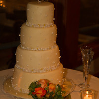 Ivory Wedding Cake With Pearls The cake looks yellow in this photo, but it was ivory fondant. Decorated with thousands of edible pearls in various sizes and shades pain...