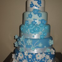 Blue And White Tiered Cake This is a 5 tier wedding cake, colors fade into one another and the flowers are gumpaste that fade in reverse order.