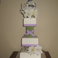 Bouquet Through The Cake This cake is covered in fondant. Flower "stems" are rolled gumpaste. This wedding cake was designed to look like the flowers go...