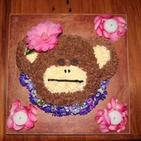 Hawaiian Monkey Monkey cake for our daughters birthday. It is a vanilla cake with chocolate buttercream. The flowers and petals are live flowers from our...