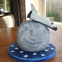 Space Shuttle Orbiting Moon Fondant and gum paste Shuttle. Moon made from yellow cake layered with strawberry jam and vanilla buttercream covered in fondant.
