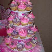 Princess Party Cupcakes in pink and purple decorated with the M1 tip, I make the tiaras with fondantI added the feather boas and tiara for props. Birthday...