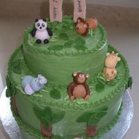 Jungle/zoo Animal Birthday Cake 2-tier chocolate cake covered in buttercream with fondant animals, leaves and trees.