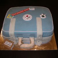 Goodbye Cake Half chocolate, half vanilla cake with raspberry flavoured buttercream filling. Suitcase and stickers decorated in fondant.