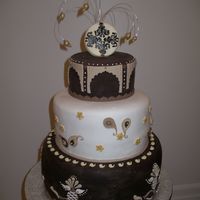 Imgp5860.jpg Three tier cake covered with vanilla and dark chocolate fondant. Design inspired by Lindy Smith's eastern cake.