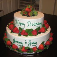 2 Tier Strawberry And Blueberries The cake is a butter cake with strawberrry filling. The icing is bc and trimmed with fresh strawberries, blueberries and mint leaves.
