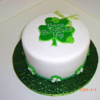 Lucky 8" round covered with fondant with green fondant ball border. Used a plastic clover decoration for top and made a bow for top. Used...